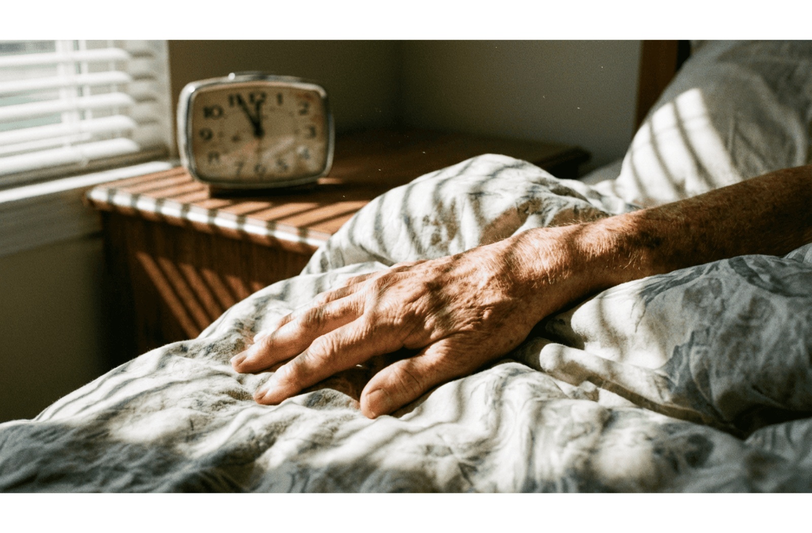 a seniors hand on a bed in a brightly lit room